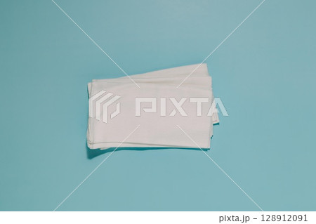 Folded White Napkins on Blue, Cleanliness and Softness 128912091