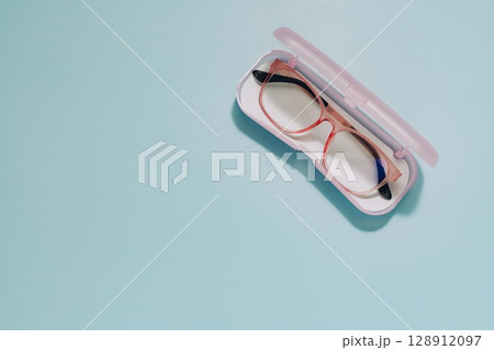 Pink Glasses in Open Case on Blue, Vision and Protection 128912097