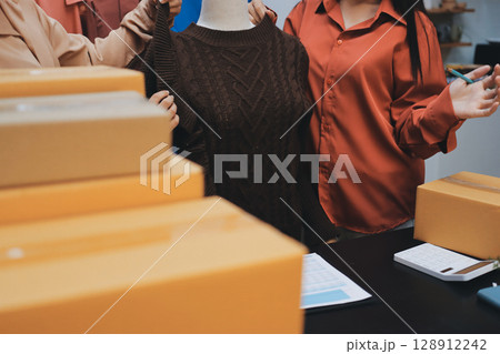 Portrait of Starting small businesses SME owners, two Asian woman check online orders Selling products working with boxs freelance work at home office, sme business online small medium enterprise 128912242