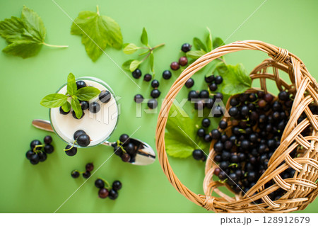 Natural berry yogurt, isolated on green surface Natural berry yogurt, isolated on green surface 128912679