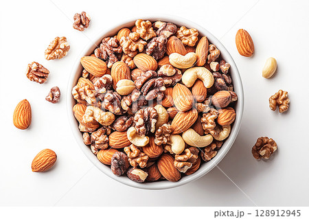 Healthy mix of almonds, walnuts and cashews in a white bowl. 128912945