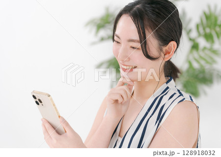 スマホを見る女性 128918032