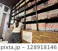 ペンションのマンガコーナーでマンガを探す少女 128918146