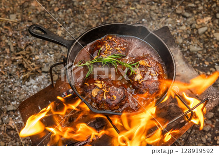 ハンバーグ Grilling homemade hamburger steaks outdoors 128919592