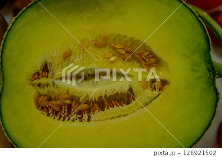 Cut in half cantaloupe melon isolated on white background Cut in half cantaloupe melon isolated on white background 128921502