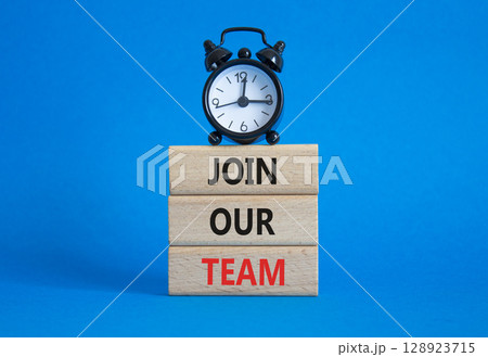 Join our team symbol. Wooden blocks with words Join our team. Beautiful blue background with alarm clock. Business and Join our team concept. Copy space. Join our team symbol. Wooden blocks with words Join our team. Beautiful blue background with alarm clock. Business and Join our team concept. Copy space. 128923715