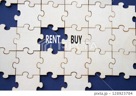 Rent or Buy symbol. Concept word Rent or Buy on wooden puzzle. Beautiful deep blue background. Business and Rent or Buy concept. Copy space Rent or Buy symbol. Concept word Rent or Buy on wooden puzzle. Beautiful deep blue background. Business and Rent or Buy concept. Copy space 128923784