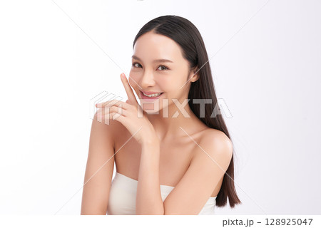 A beautiful young Asian woman with clean, fresh skin against a white background. Skincare, facial treatment, cosmetology, beauty, and spa. An elegant portrait of an Asian woman. A beautiful young Asian woman with clean, fresh skin against a white background. Skincare, facial treatment, cosmetology, beauty, and spa. An elegant portrait of an Asian woman. 128925047