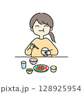 ご飯をもりもり食べる女性 128925954