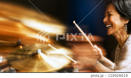 Enthusiastic drummer performing live in jazz club with blurred motion 128926619