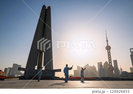 people exercise Tai Chi at People's and pearl tower at sunrise, Shanghai 128926855