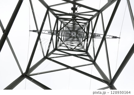 A tall metal structure with a lot of wires and cables A tall metal structure with a lot of wires and cables 128930164