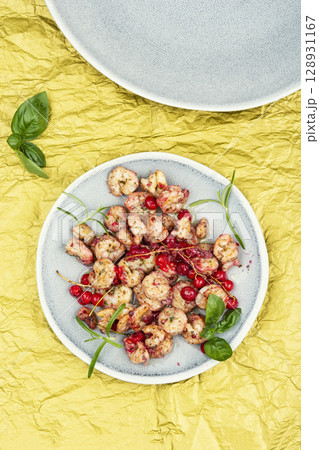 Grilled shrimps or prawns served with berry. Grilled shrimps or prawns served with berry. 128931167