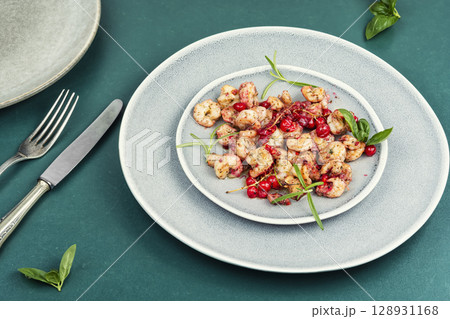 Fried seafood shrimps with berries sauce. 128931168
