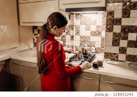 Woman Kitchen Cooking Coffee: Home cooking preparation, modern kitchen, woman making coffee. Woman Kitchen Cooking Coffee: Home cooking preparation, modern kitchen, woman making coffee. 128931245