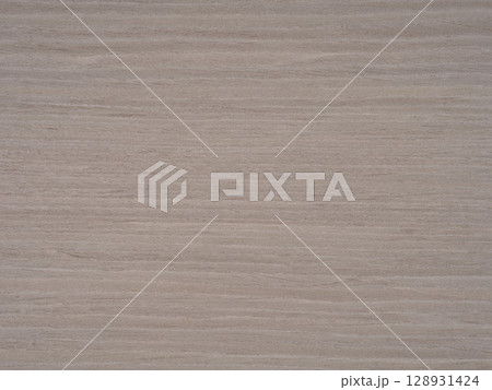 Gentle gradients of gray and muted earth tones cascade across the sturdy ash wood veneer, offering a canvas of understated elegance 128931424