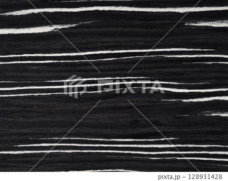 Ebony and ivory veneer surface with bold, rhythmic stripes creating a striking visual contrast Ebony and ivory veneer surface with bold, rhythmic stripes creating a striking visual contrast 128931428