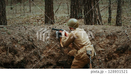 Soldier Aiming in a Forest During Historical Warfare Scene. Soviet Russian Soldier Aiming With Rifles. Soldiers Shoots With Rifle. Soviet Russian Soldier Uniform 128931521