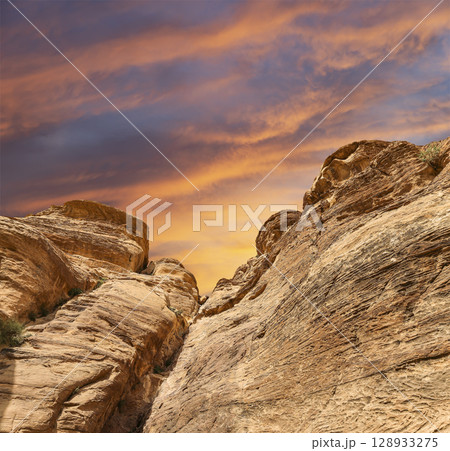 Mountains of Petra (against the background of a beautiful sky with clouds), Jordan, Middle East. Petra has been a UNESCO World Heritage Site since 1985 128933275