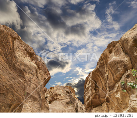 Mountains of Petra (against the background of a beautiful sky with clouds), Jordan, Middle East. Petra has been a UNESCO World Heritage Site since 1985 Mountains of Petra (against the background of a beautiful sky with clouds), Jordan, Middle East. Petra has been a UNESCO World Heritage Site since 1985 128933283