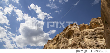 Mountains of Petra (against the background of a beautiful sky with clouds), Jordan, Middle East. Petra has been a UNESCO World Heritage Site since 1985 Mountains of Petra (against the background of a beautiful sky with clouds), Jordan, Middle East. Petra has been a UNESCO World Heritage Site since 1985 128933290