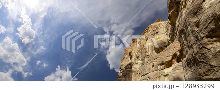 Mountains of Petra (against the background of a beautiful sky with clouds), Jordan, Middle East. Petra has been a UNESCO World Heritage Site since 1985 Mountains of Petra (against the background of a beautiful sky with clouds), Jordan, Middle East. Petra has been a UNESCO World Heritage Site since 1985 128933299