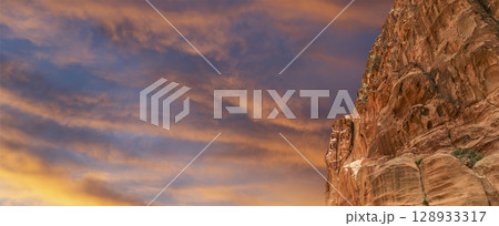 Mountains of Petra (against the background of a beautiful sky with clouds), Jordan, Middle East. Petra has been a UNESCO World Heritage Site since 1985 128933317