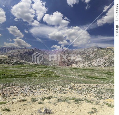Typical mountain landscape, Jordan, Middle East (photography from a high point). Against the background of a beautiful sky with clouds Typical mountain landscape, Jordan, Middle East (photography from a high point). Against the background of a beautiful sky with clouds 128933555