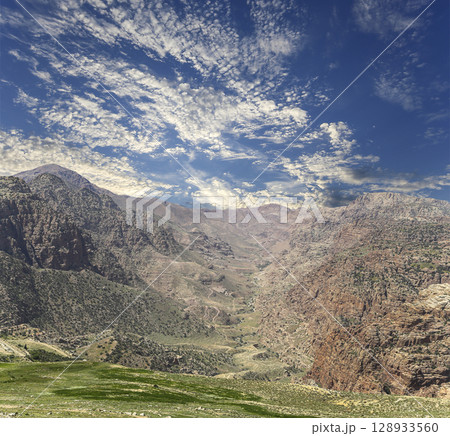 Typical mountain landscape, Jordan, Middle East (photography from a high point). Against the background of a beautiful sky with clouds Typical mountain landscape, Jordan, Middle East (photography from a high point). Against the background of a beautiful sky with clouds 128933560
