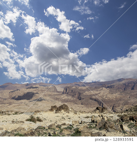 Typical mountain landscape, Jordan, Middle East (photography from a high point). Against the background of a beautiful sky with clouds Typical mountain landscape, Jordan, Middle East (photography from a high point). Against the background of a beautiful sky with clouds 128933591