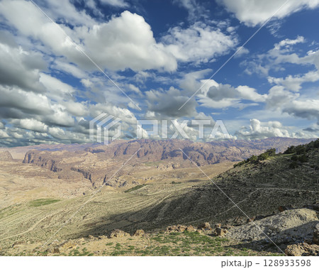 Typical mountain landscape, Jordan, Middle East (photography from a high point). Against the background of a beautiful sky with clouds Typical mountain landscape, Jordan, Middle East (photography from a high point). Against the background of a beautiful sky with clouds 128933598