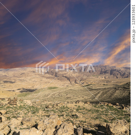 Typical mountain landscape, Jordan, Middle East (photography from a high point). Against the background of a beautiful sky with clouds Typical mountain landscape, Jordan, Middle East (photography from a high point). Against the background of a beautiful sky with clouds 128933601