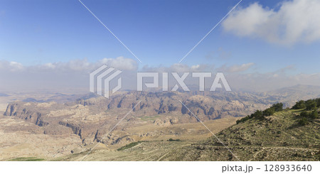 Typical mountain landscape (panoramic view), Jordan, Middle East (photography from a high point). Against the background of a beautiful sky with clouds Typical mountain landscape (panoramic view), Jordan, Middle East (photography from a high point). Against the background of a beautiful sky with clouds 128933640