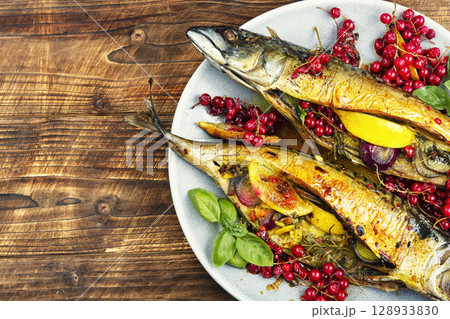 Oven baked mackerel on wooden surface. Oven baked mackerel on wooden surface. 128933830