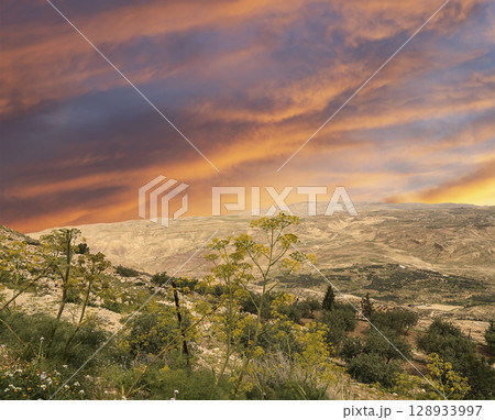 Typical mountain landscape, Jordan, Middle East (photography from a high point). Against the background of a beautiful sky with clouds Typical mountain landscape, Jordan, Middle East (photography from a high point). Against the background of a beautiful sky with clouds 128933997