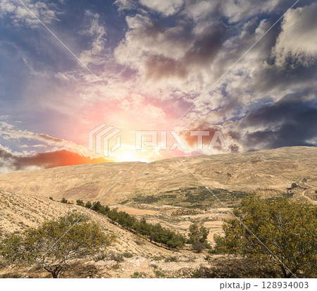 Typical mountain landscape, Jordan, Middle East (photography from a high point). Against the background of a beautiful sky with clouds Typical mountain landscape, Jordan, Middle East (photography from a high point). Against the background of a beautiful sky with clouds 128934003