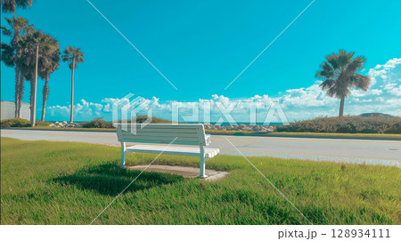 Relaxing bench overlooking the peaceful beach 128934111