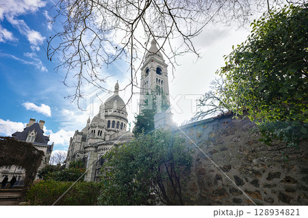 View of Sacre Coeur Basilica through tree branches in Montmartre View of Sacre Coeur Basilica through tree branches in Montmartre 128934821