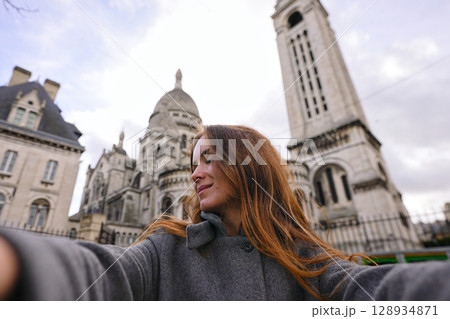 Happy tourist woman taking selfie near Sacre Coeur Basilica Paris Happy tourist woman taking selfie near Sacre Coeur Basilica Paris 128934871