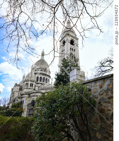 Sacre Coeur Basilica in Montmartre Paris with tree branches in view 128934872