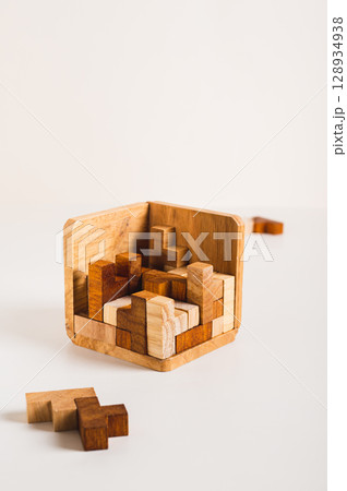 Wooden figures puzzles stacked in a box leisure game vertical view Wooden figures puzzles stacked in a box leisure game vertical view 128934938