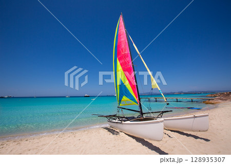 Catamaran sailboat in Illetes beach of Formentera Catamaran sailboat in Illetes beach of Formentera 128935307