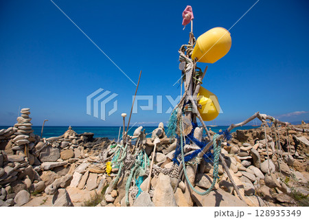 Stone figures on beach shore of Illetes beach in Formentera Stone figures on beach shore of Illetes beach in Formentera 128935349