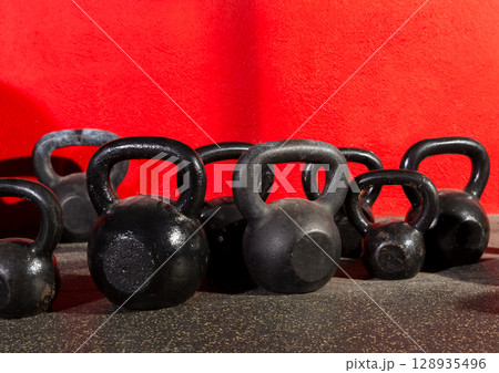 Kettlebells weights in a workout gym 128935496