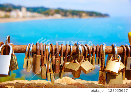 Costa Brava beach Lloret de Mar padlocks in a row 128935637