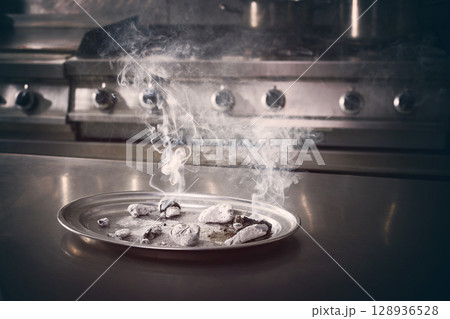 charcoal ashes smoke in a stainless kitchen charcoal ashes smoke in a stainless kitchen 128936528
