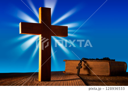 Christian wood cross on blue sky Christian wood cross on blue sky 128936533