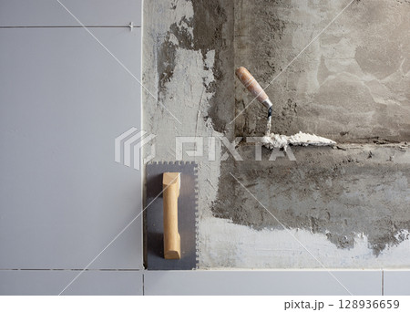 construction tools notched trowel with mortar construction tools notched trowel with mortar 128936659