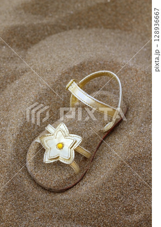 golden star sandal buried in summer beach sand golden star sandal buried in summer beach sand 128936667