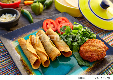 Mexican flautas rolled tacos with salsa 128937076